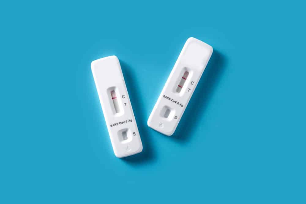 Zwei COVID-19-Schnelltests auf blauem Hintergrund